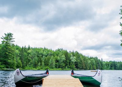 An image of the canoe docks on Saw Lake in Muskoka Ontario at the Wenonah Outdoor Education Centre.