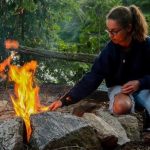 Student enjoys backcountry cooking activity during school group visit program at Wenonah Outdoor Centre in Muskoka Ontario