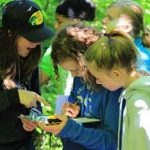 Students in geocaching program activity at Wenonah Outdoor Centre during school group visit in Muskoka Ontario
